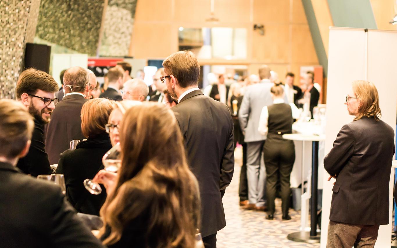 Crowd of people socializing in a conference space